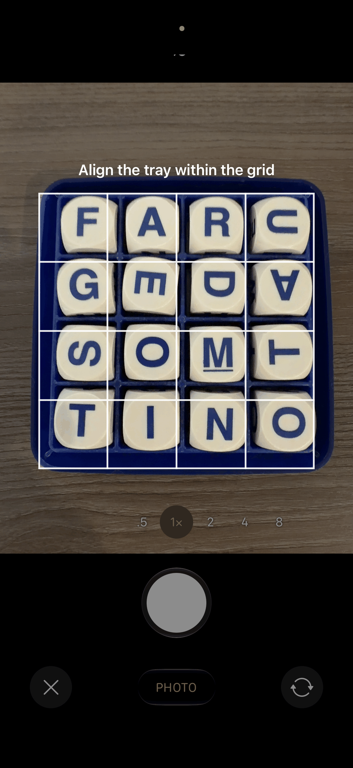 Camera view lining up a real Boggle tray within the on-screen 4×4 grid